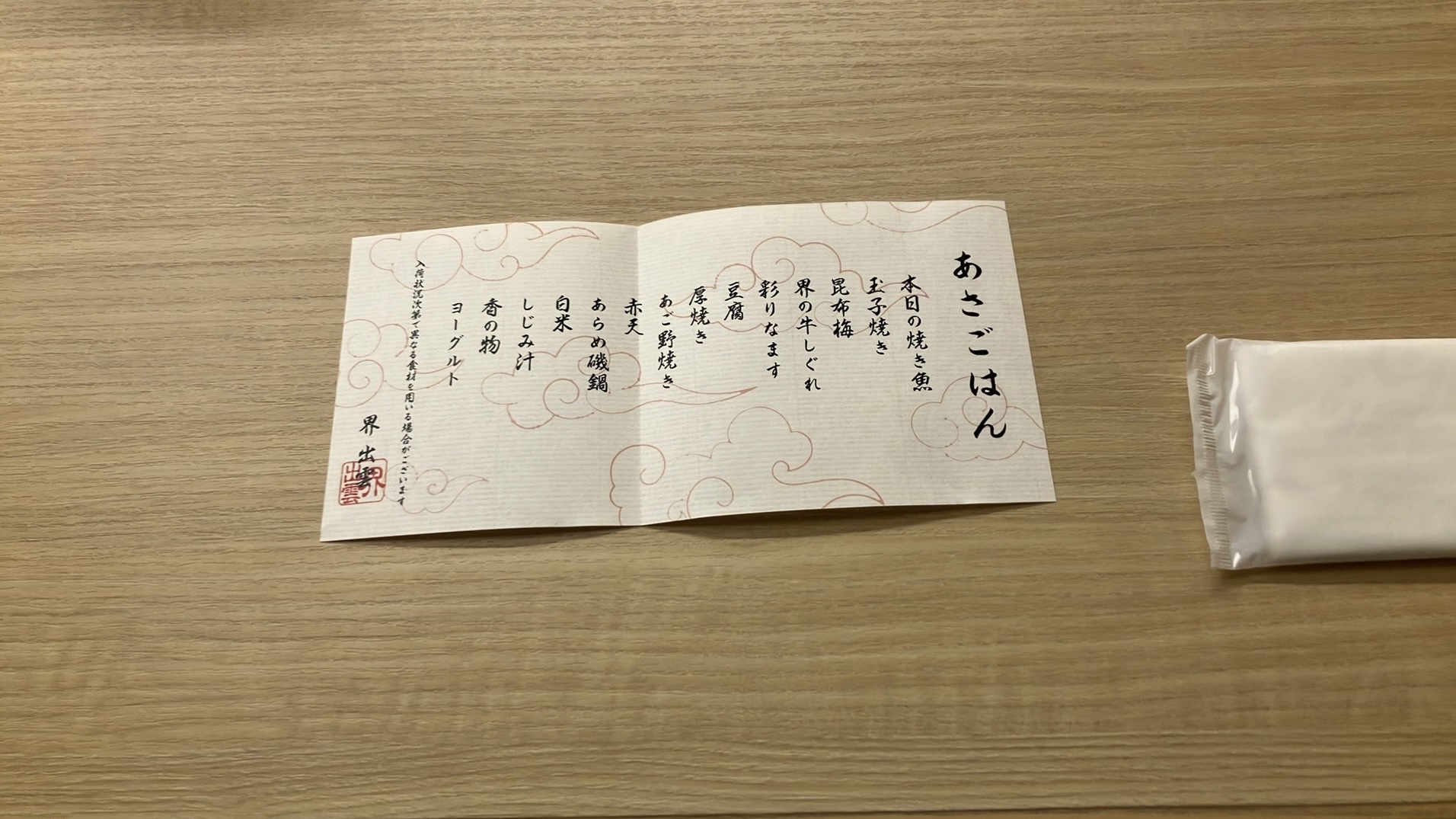 お品書きを開いたところ。本日の焼き魚、卵焼き、昆布梅、界の牛しぐれ、彩りなます、豆腐、厚焼き、あご野焼き、赤天、あらめ磯鍋、白米、しじみ汁、香の物、ヨーグルトとのこと。